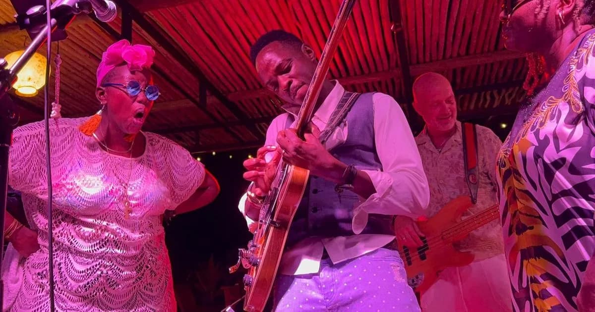 Live band lighting up the night under thatch